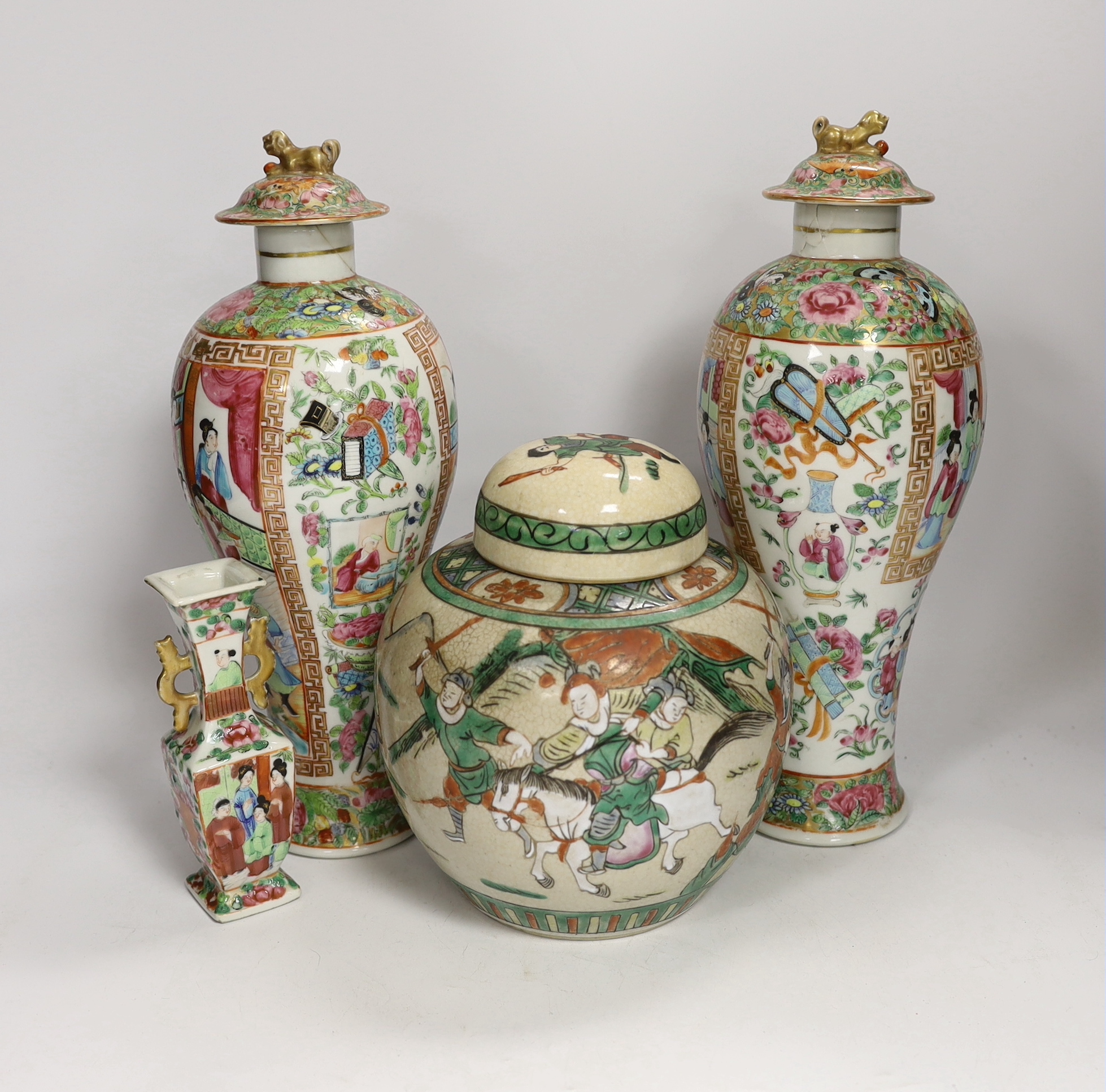 A pair of 19th century Chinese famille rose vases and covers, a similar small vase and a a famille verte crackle glaze jar, tallest 31cm